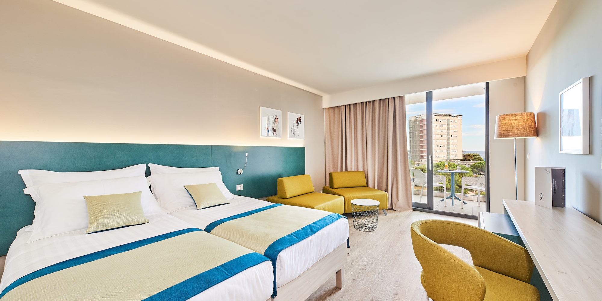 a room with two beds and a table and chairs