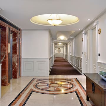a hallway with a marble floor and a table