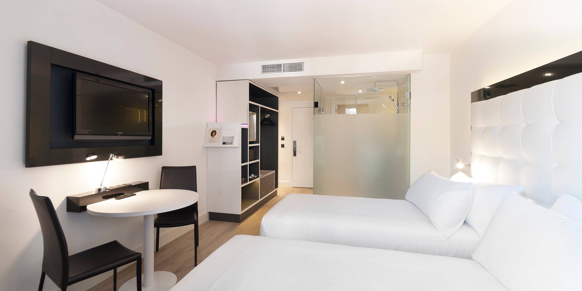 a room with two beds and a tv