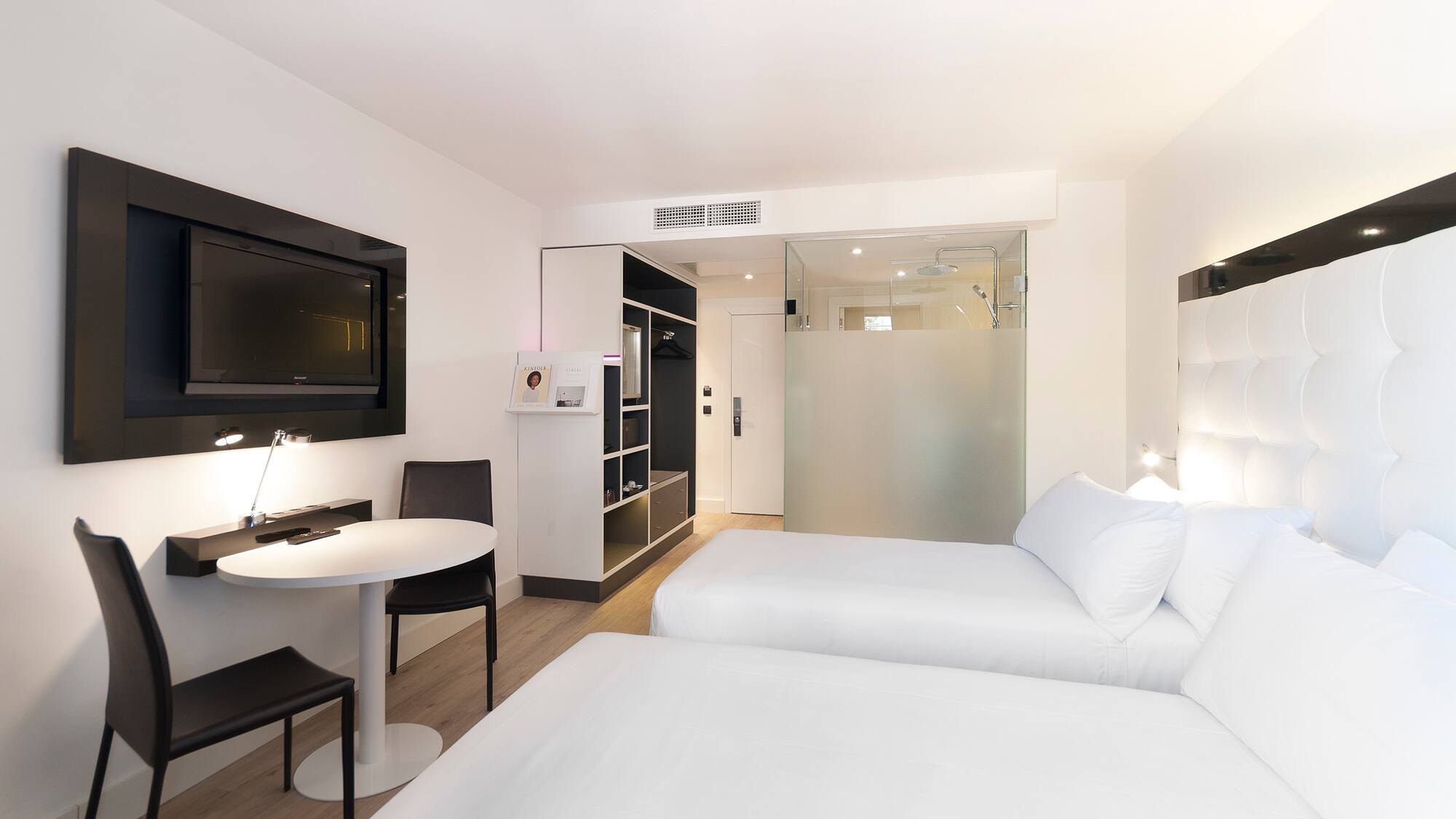 a room with two beds and a tv