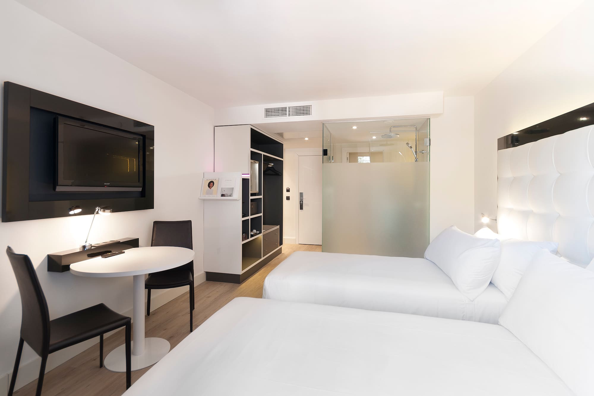 a room with two beds and a tv