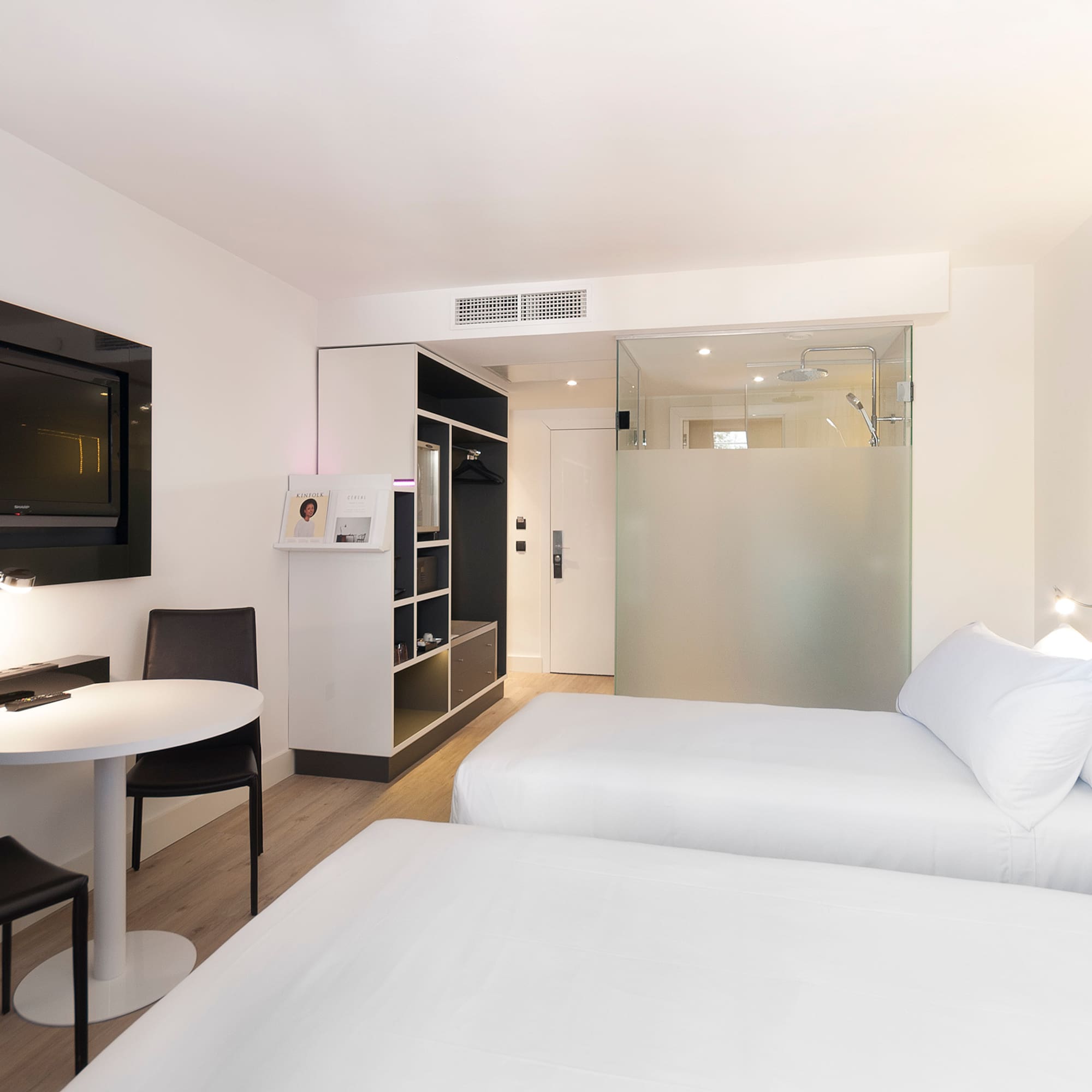 a room with two beds and a tv