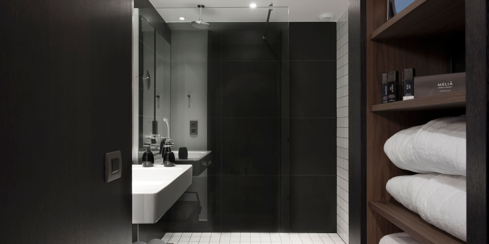 a bathroom with a glass shower door and a sink