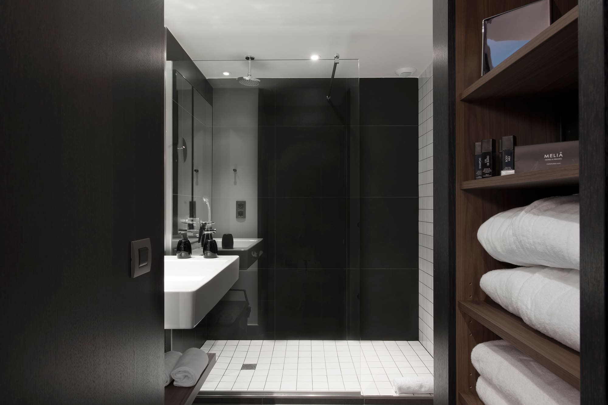 a bathroom with a glass shower door and a sink