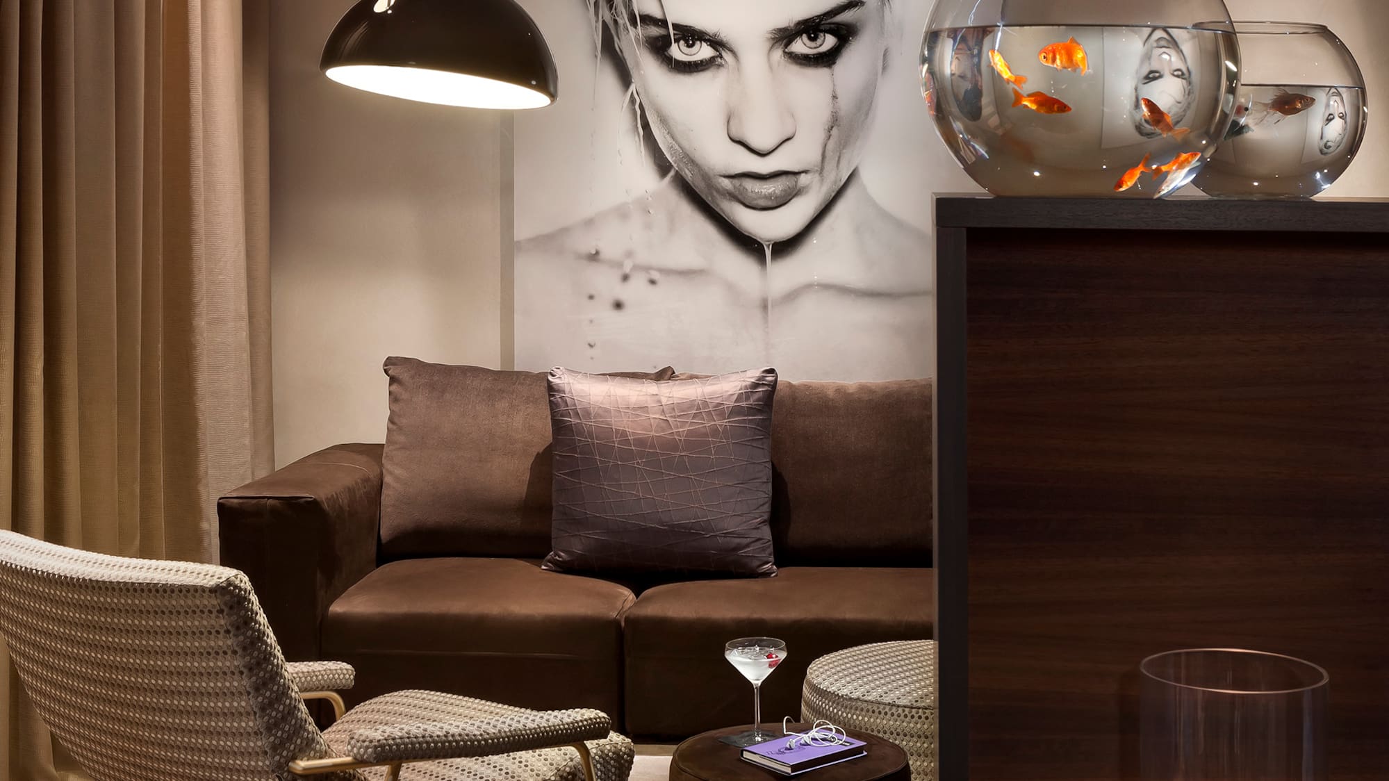 a living room with a couch and fish bowl