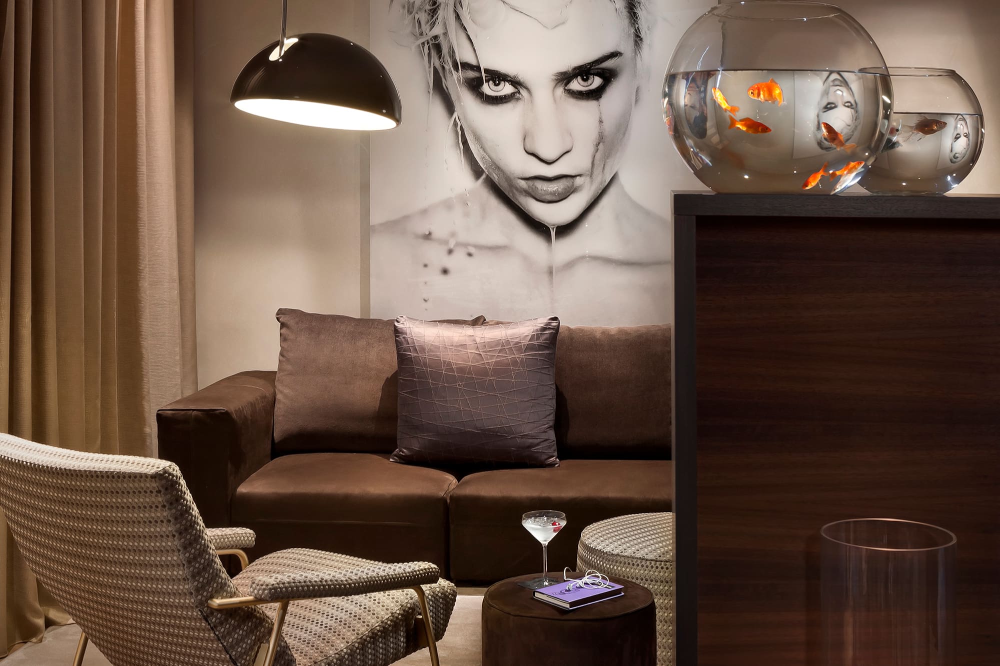 a living room with a couch and fish bowl