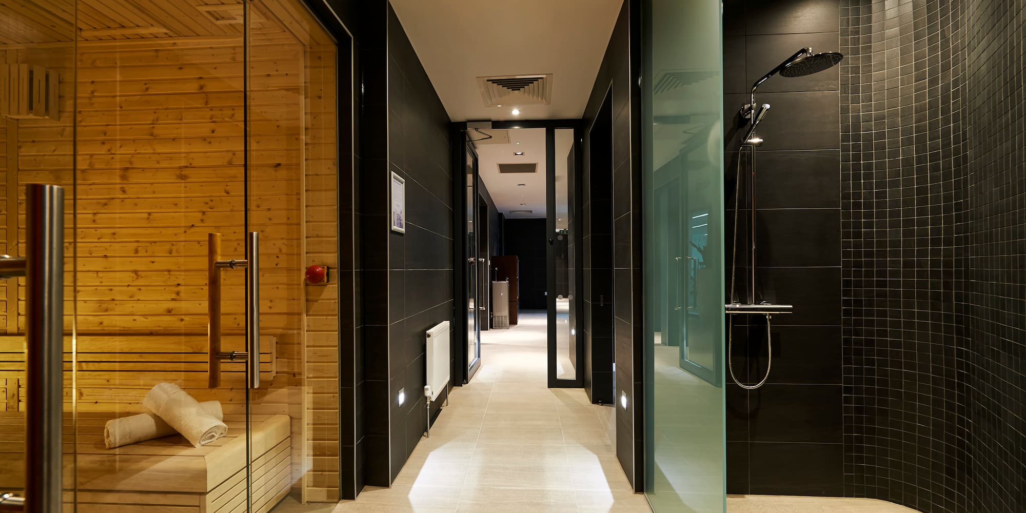 a bathroom with a wood sauna and a wooden bench