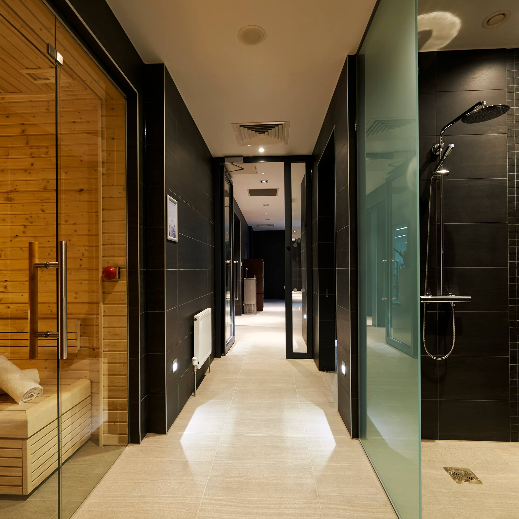 a bathroom with a wood sauna and a wooden bench