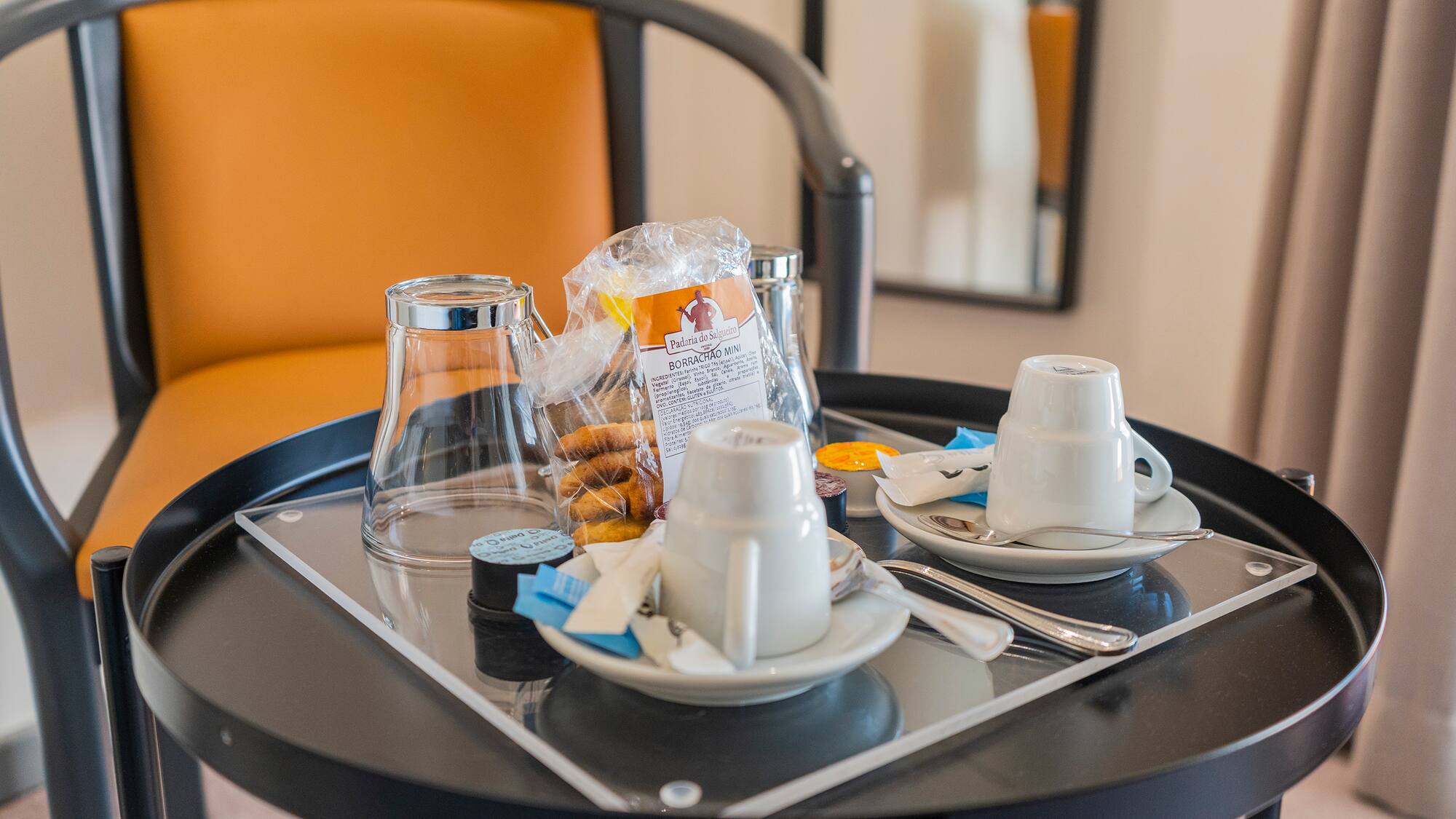 a tray with coffee cups and tea cups on it