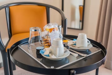a tray with coffee cups and tea cups on it