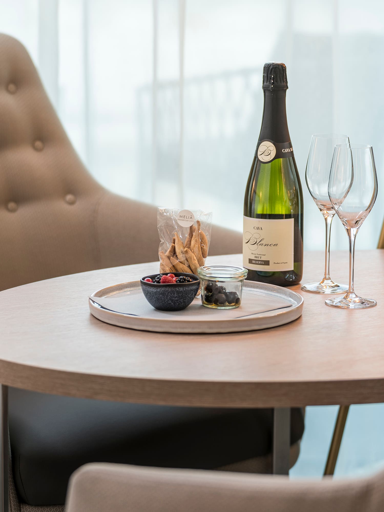 a table with a bottle of wine and glasses