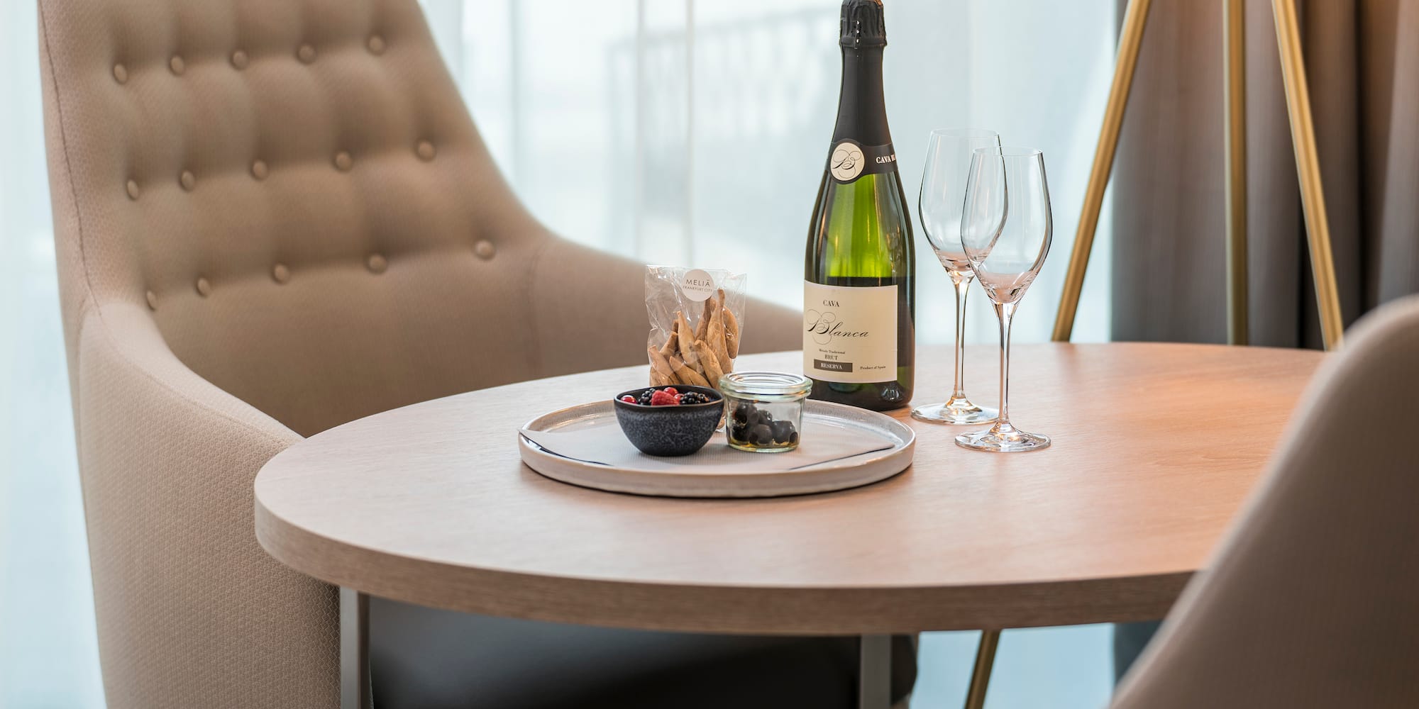 a table with a bottle of wine and glasses