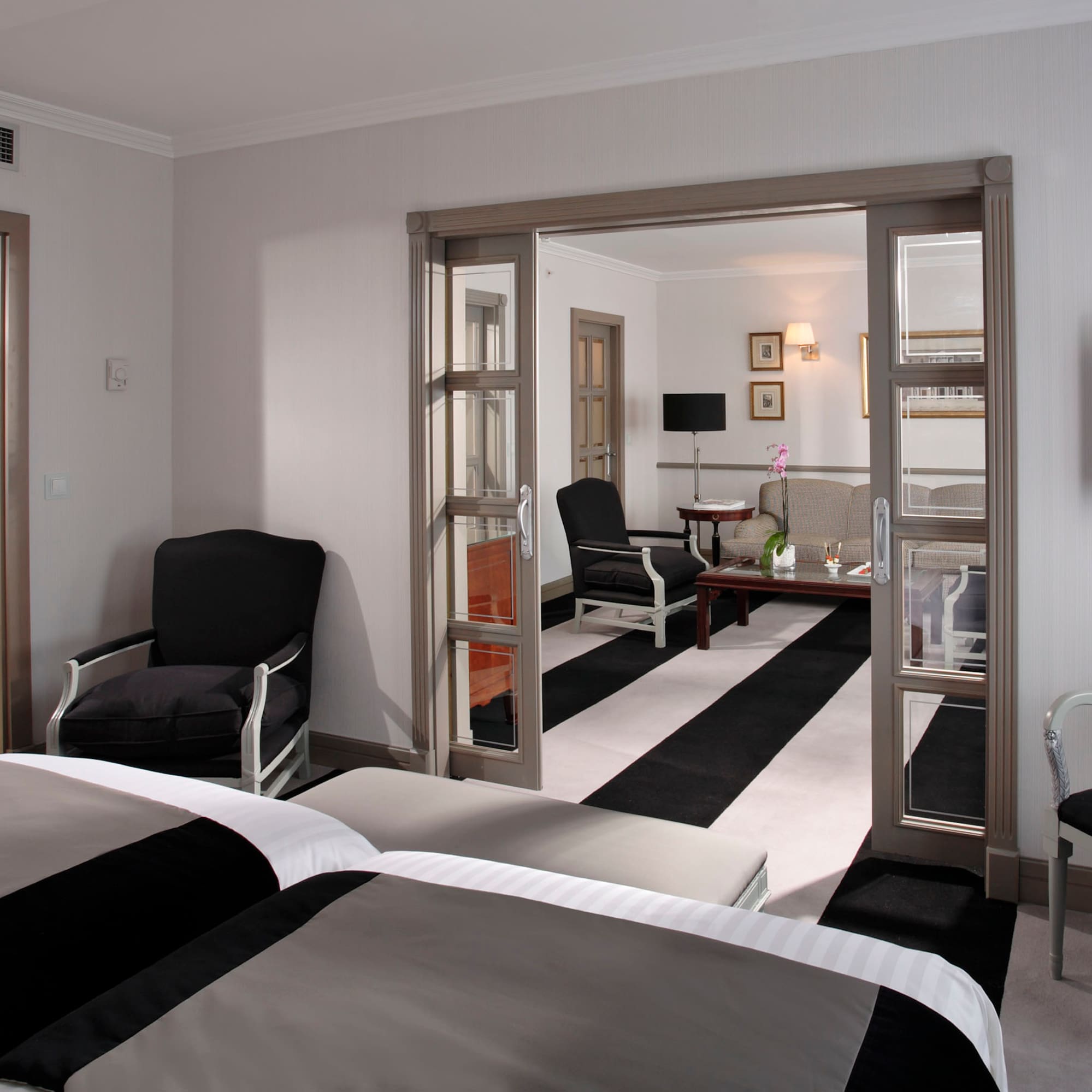 a room with two beds and a black and white striped carpet