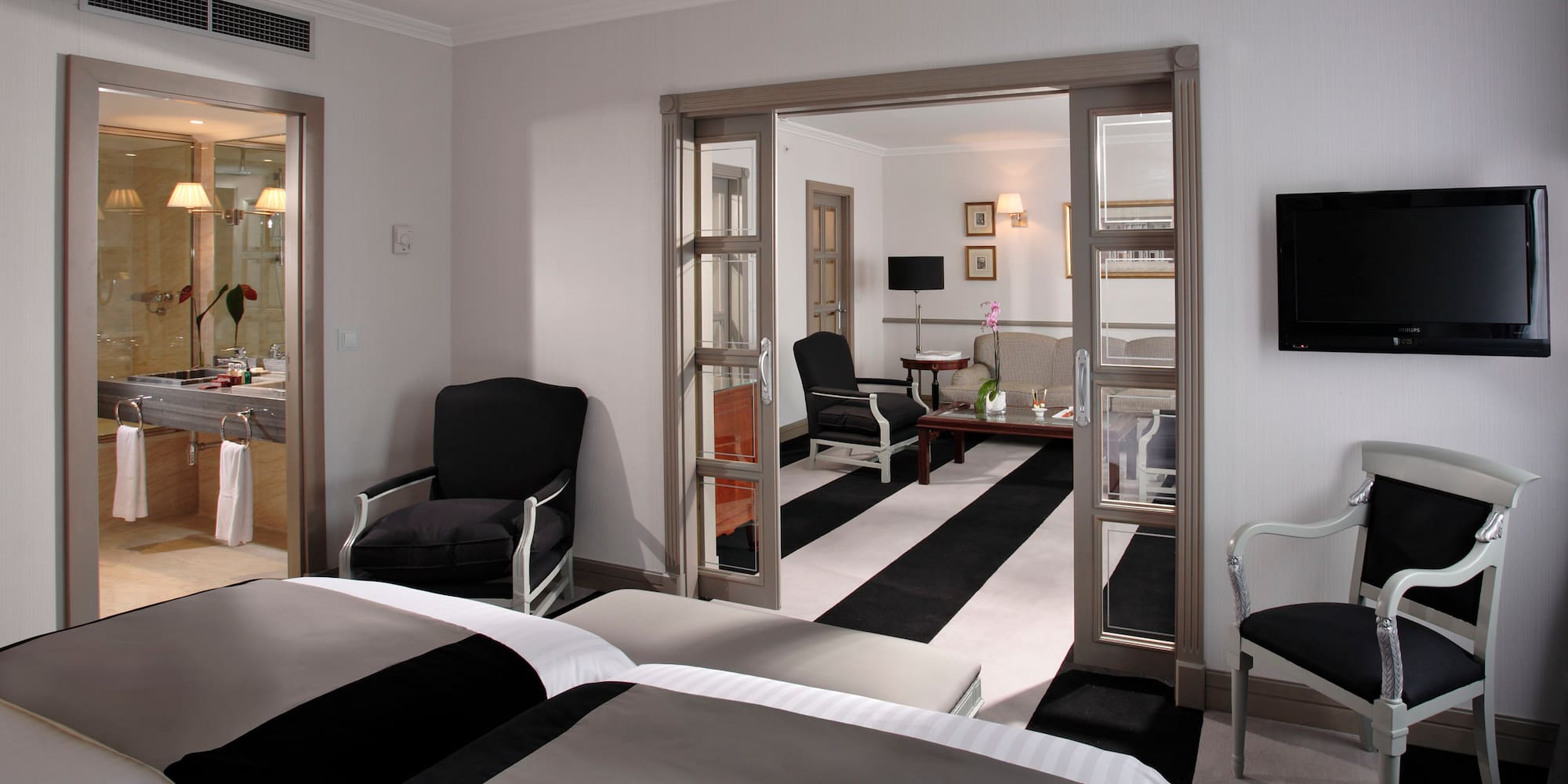 a room with two beds and a black and white striped carpet