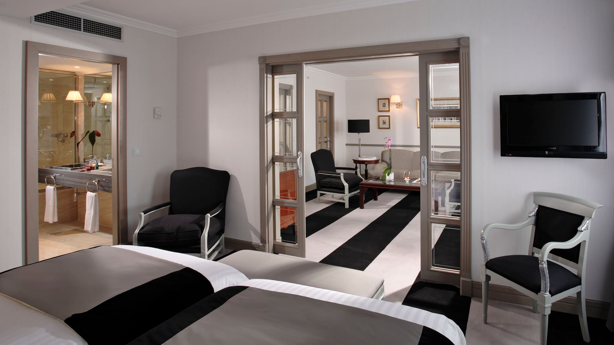 a room with two beds and a black and white striped carpet