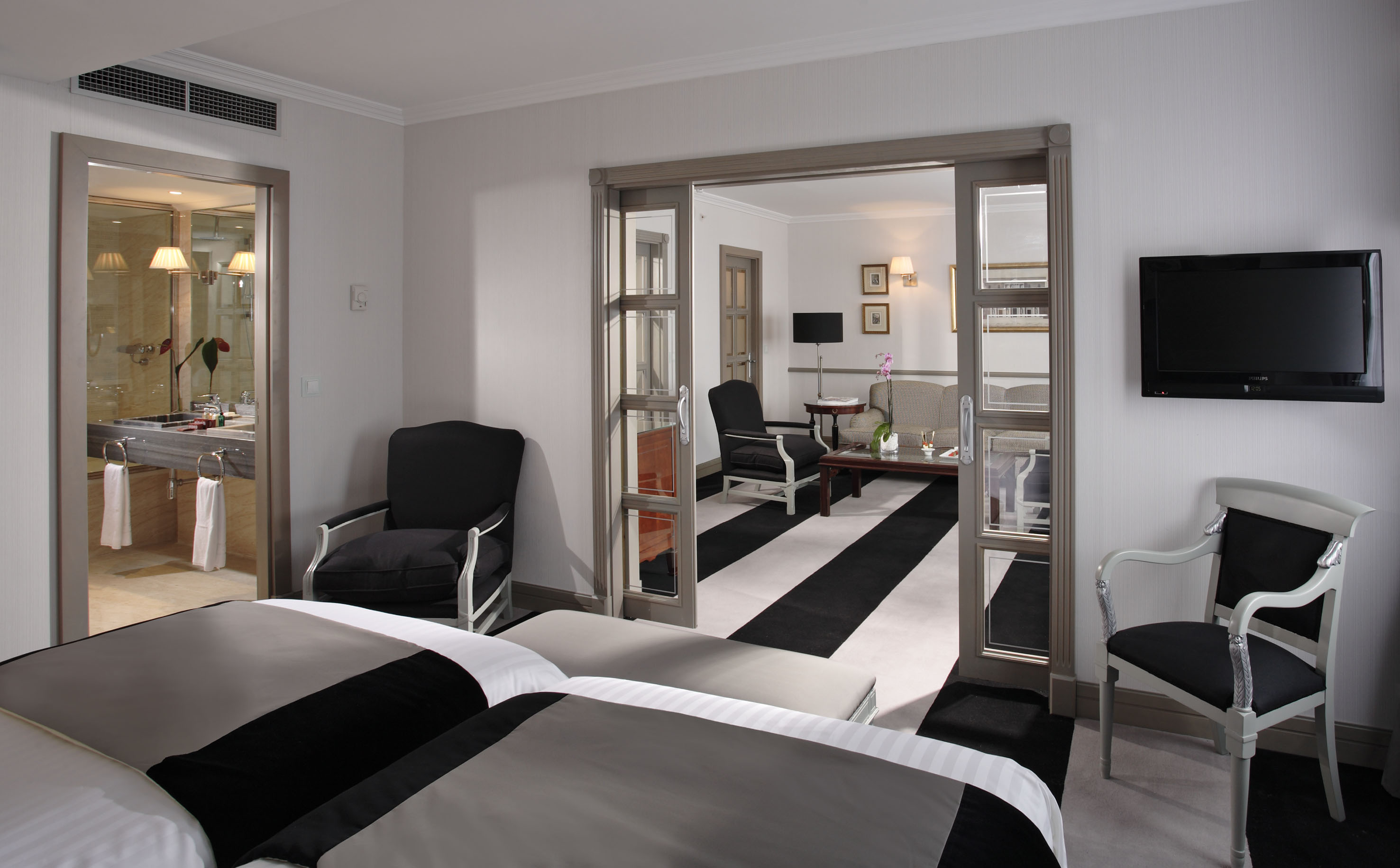 a room with two beds and a black and white striped carpet