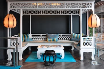 a white bench with pillows in a room