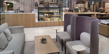 a room with a coffee table and chairs