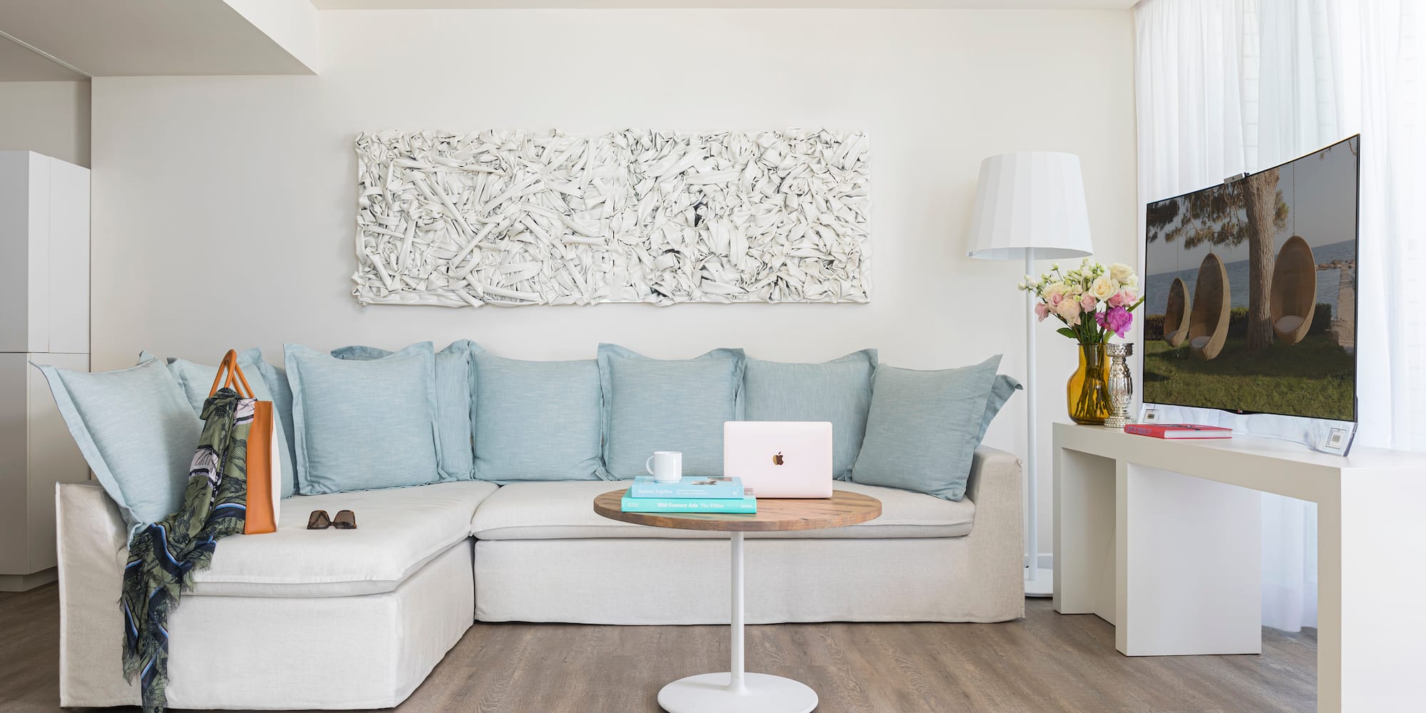 a living room with a couch and a laptop