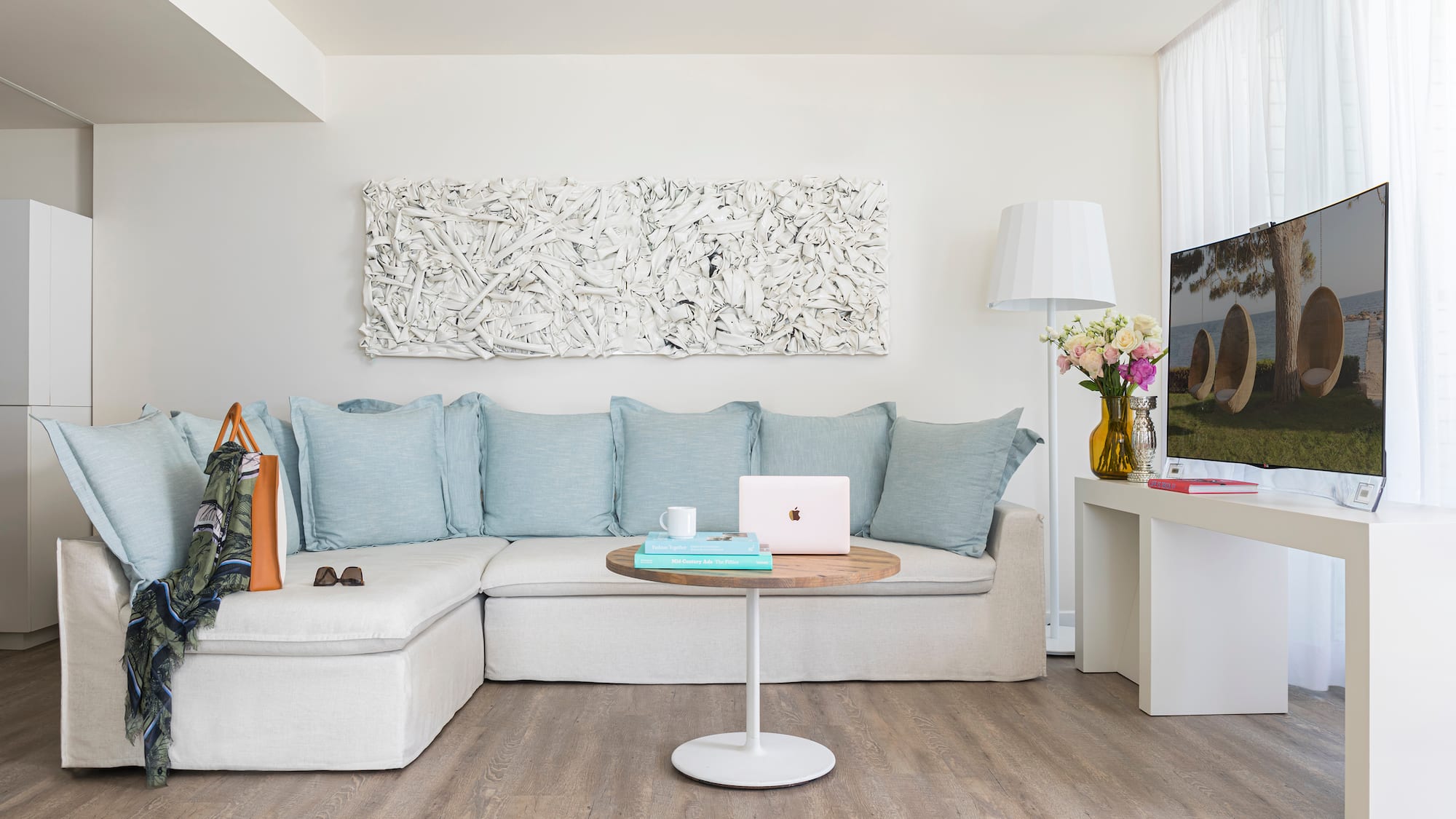 a living room with a couch and a laptop