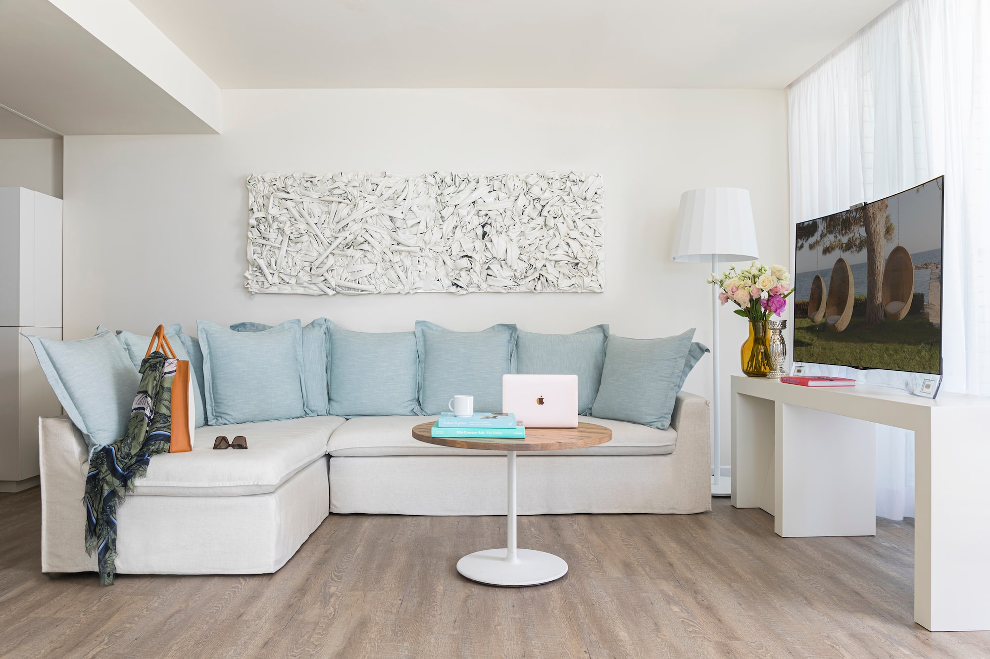 a living room with a couch and a laptop
