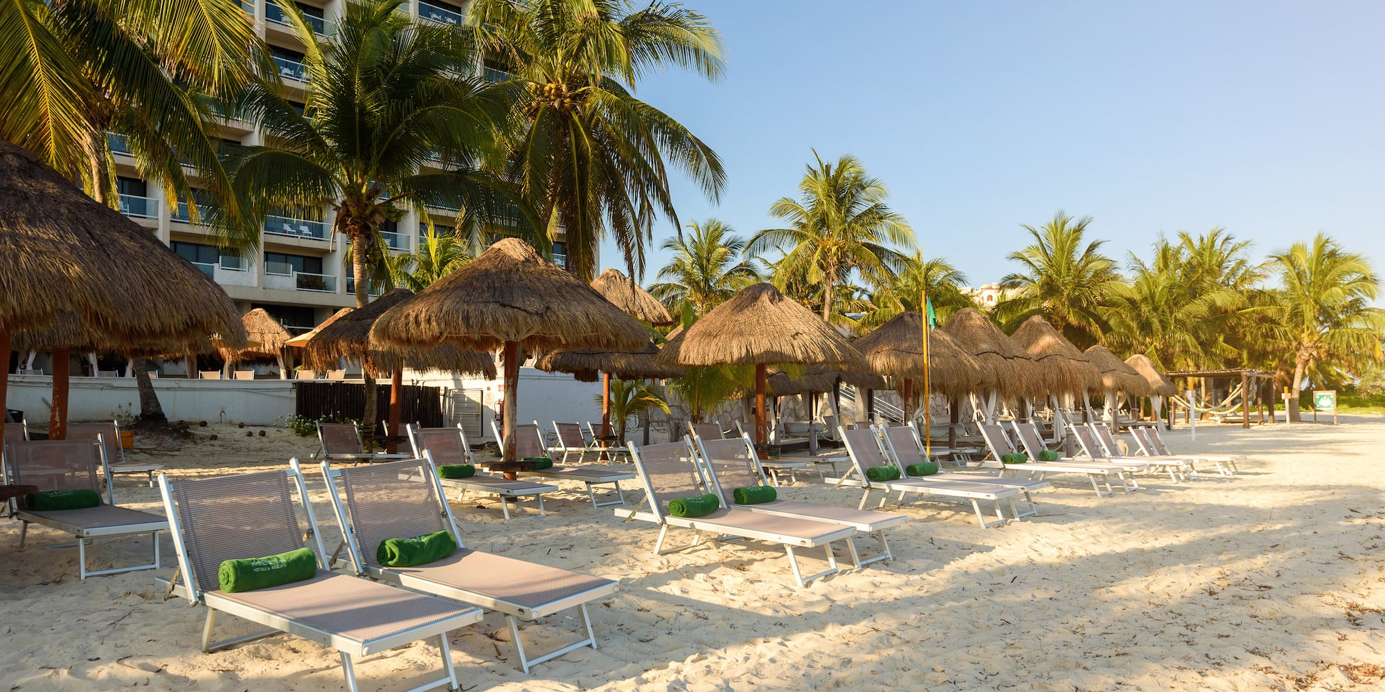 a beach with chairs and umbrellas