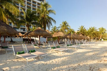 a beach with chairs and umbrellas