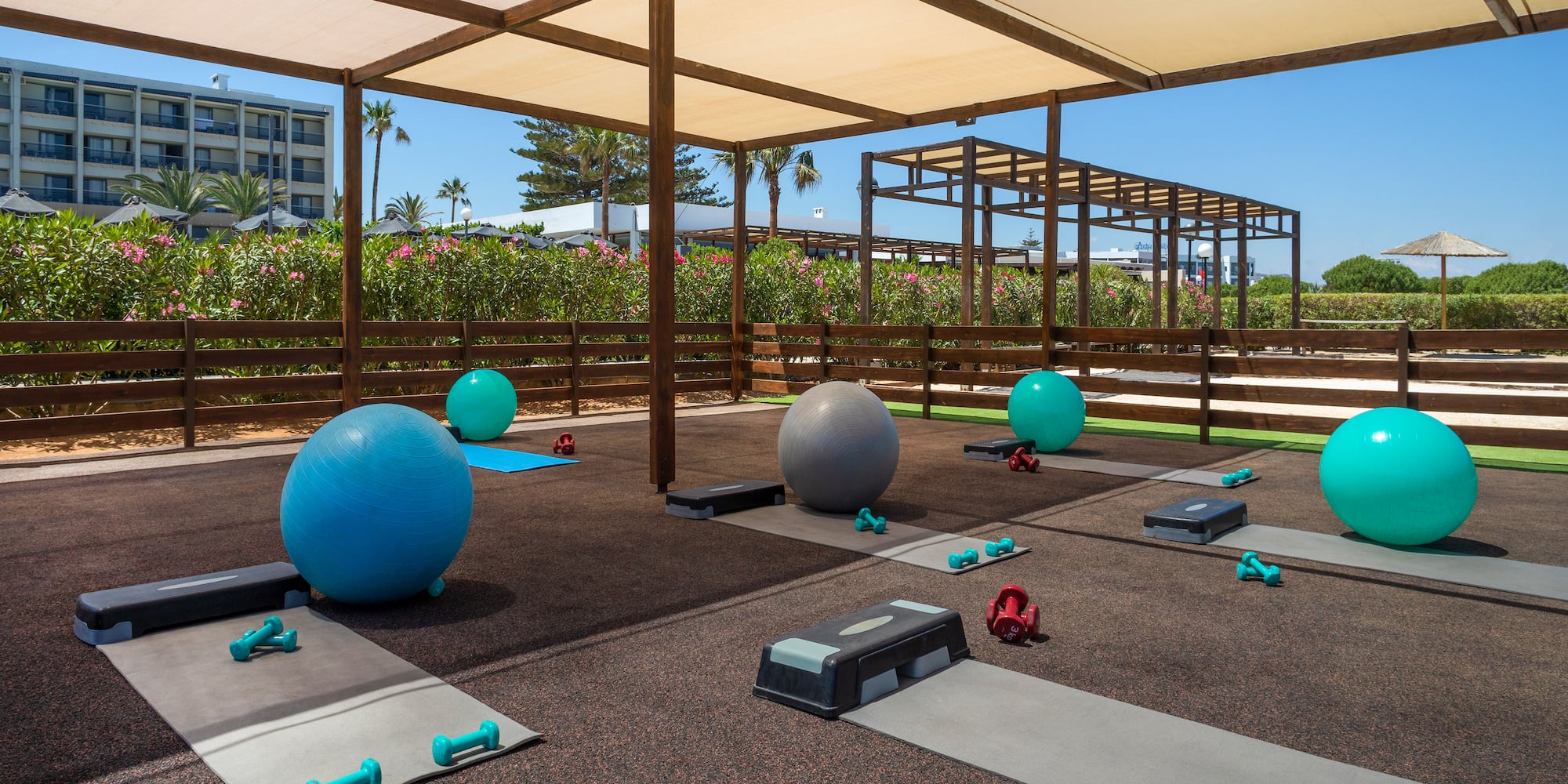 a group of yoga mats and balls on mats