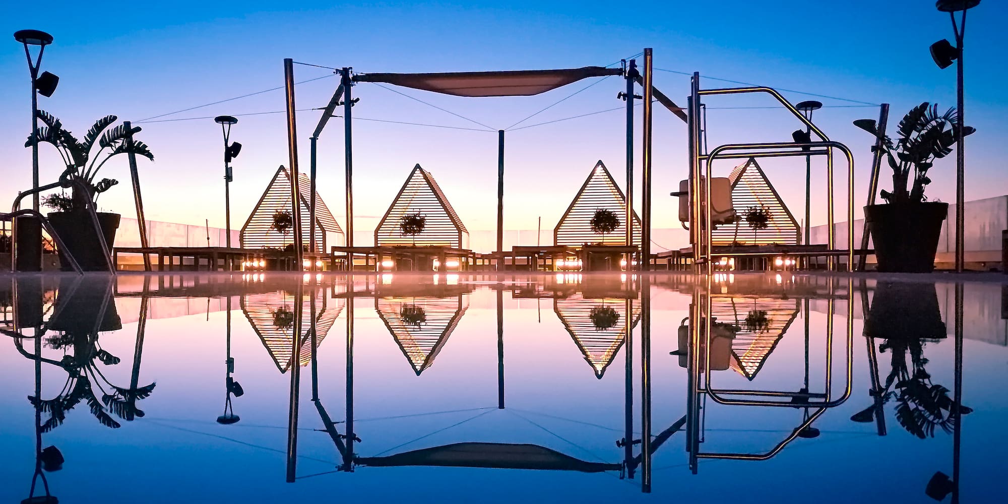 a pool with a structure and a beach