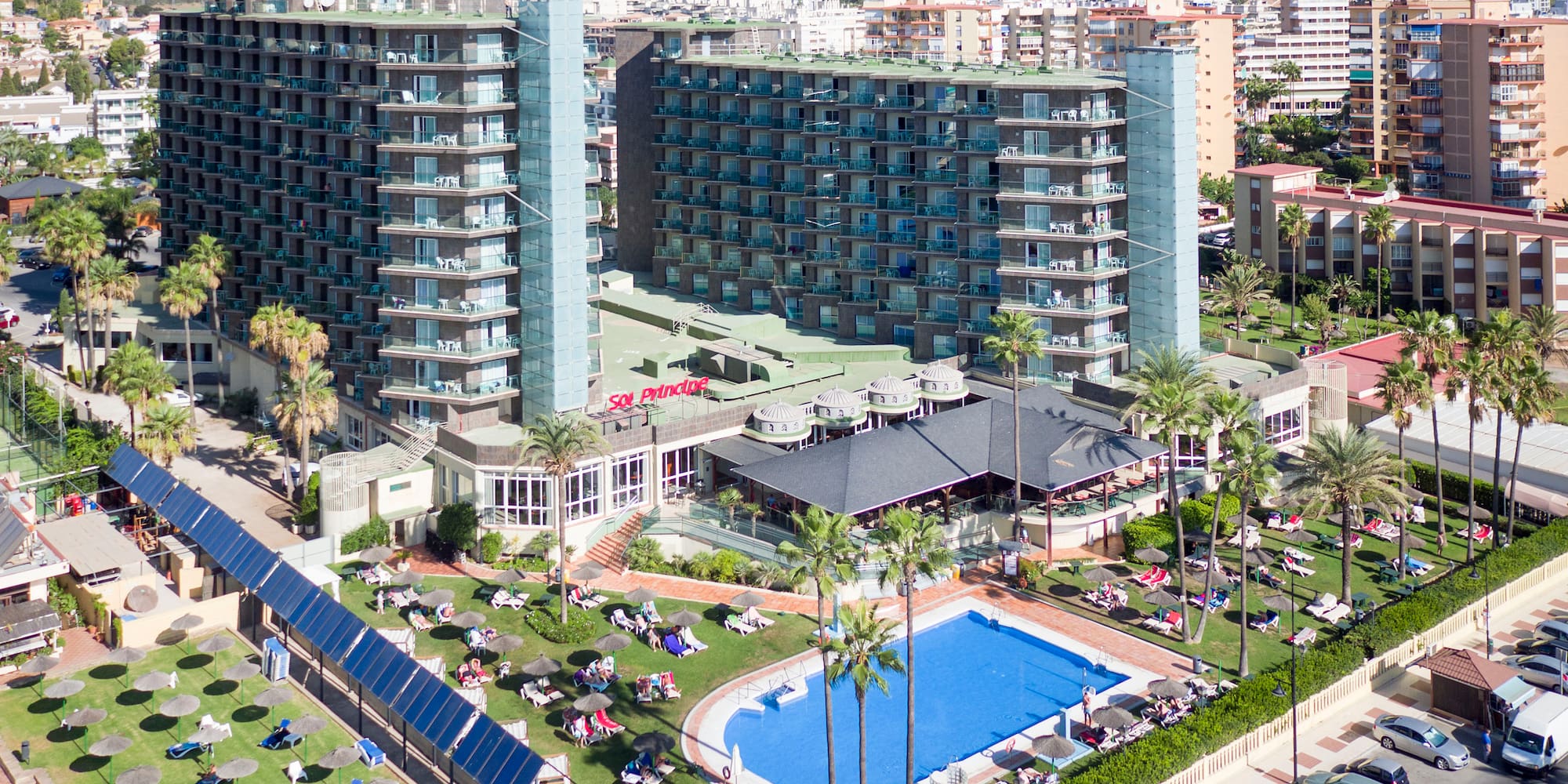 a large building with a pool and trees