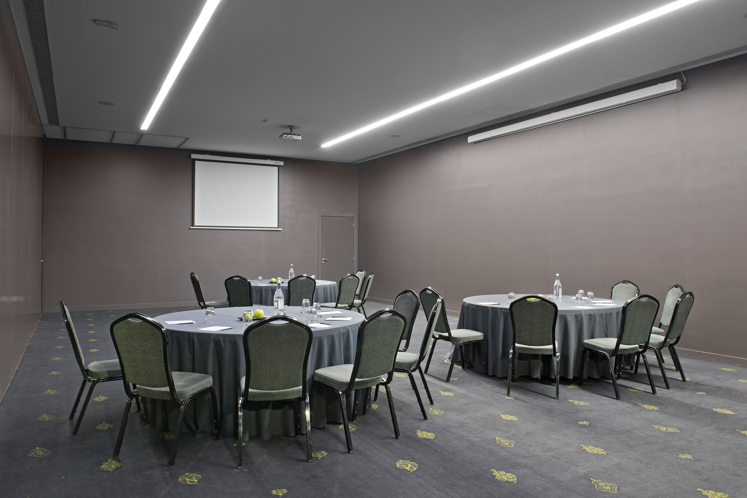 a room with round tables and chairs