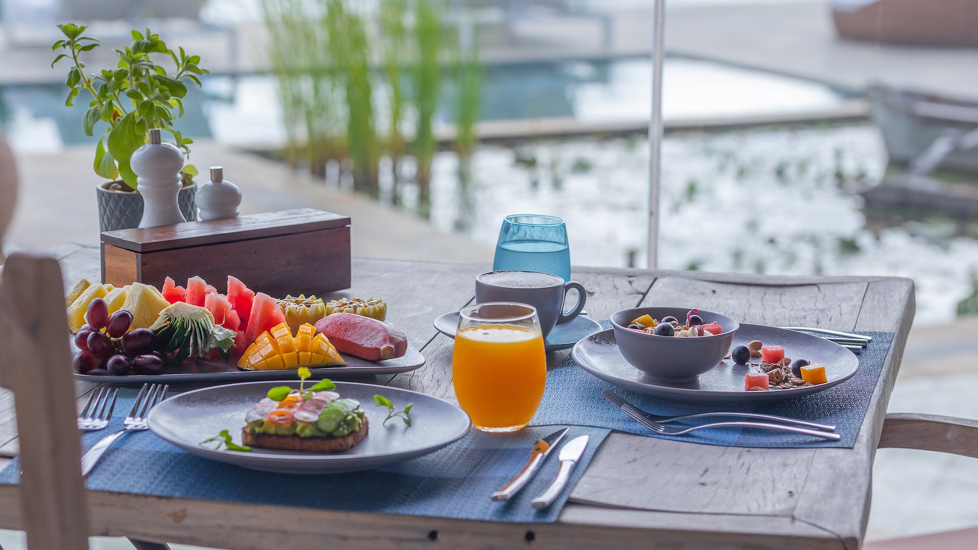a table with plates of food and drinks