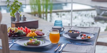 a table with plates of food and drinks