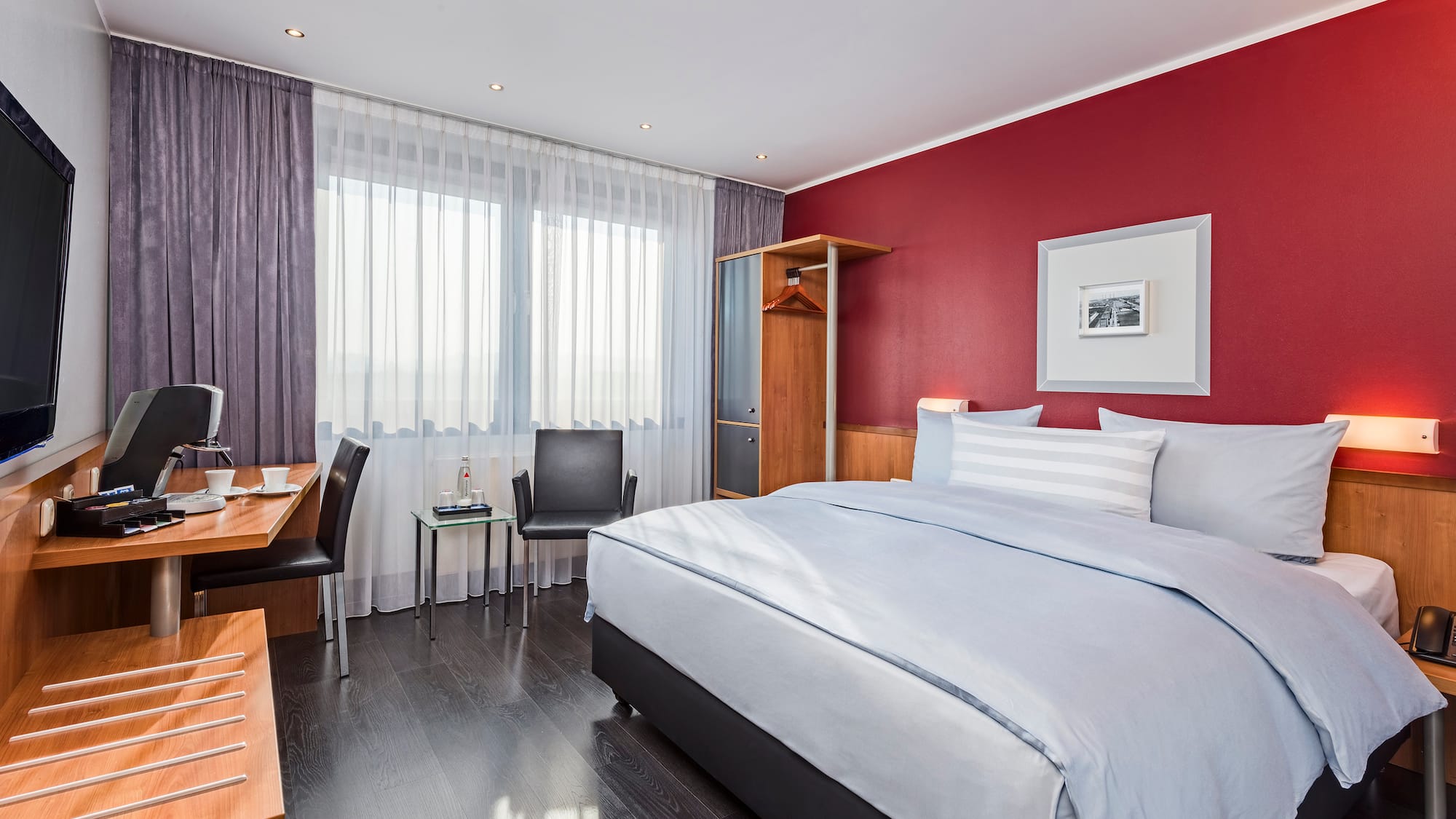 a bedroom with a bed and a desk