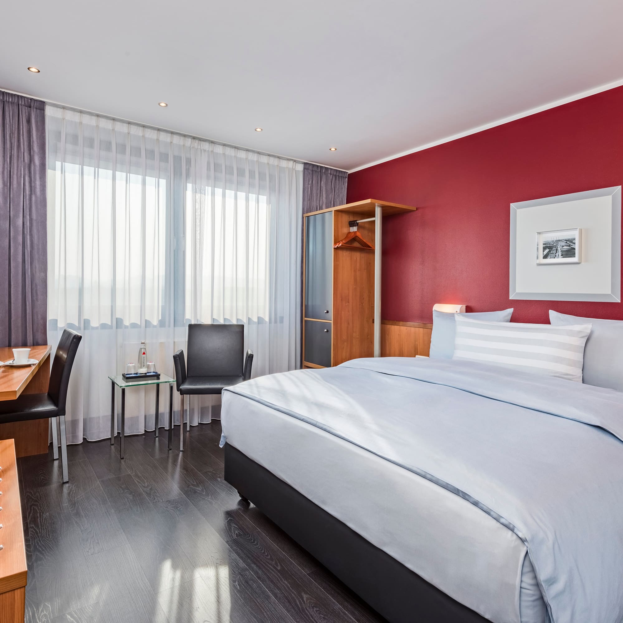 a bedroom with a bed and a desk