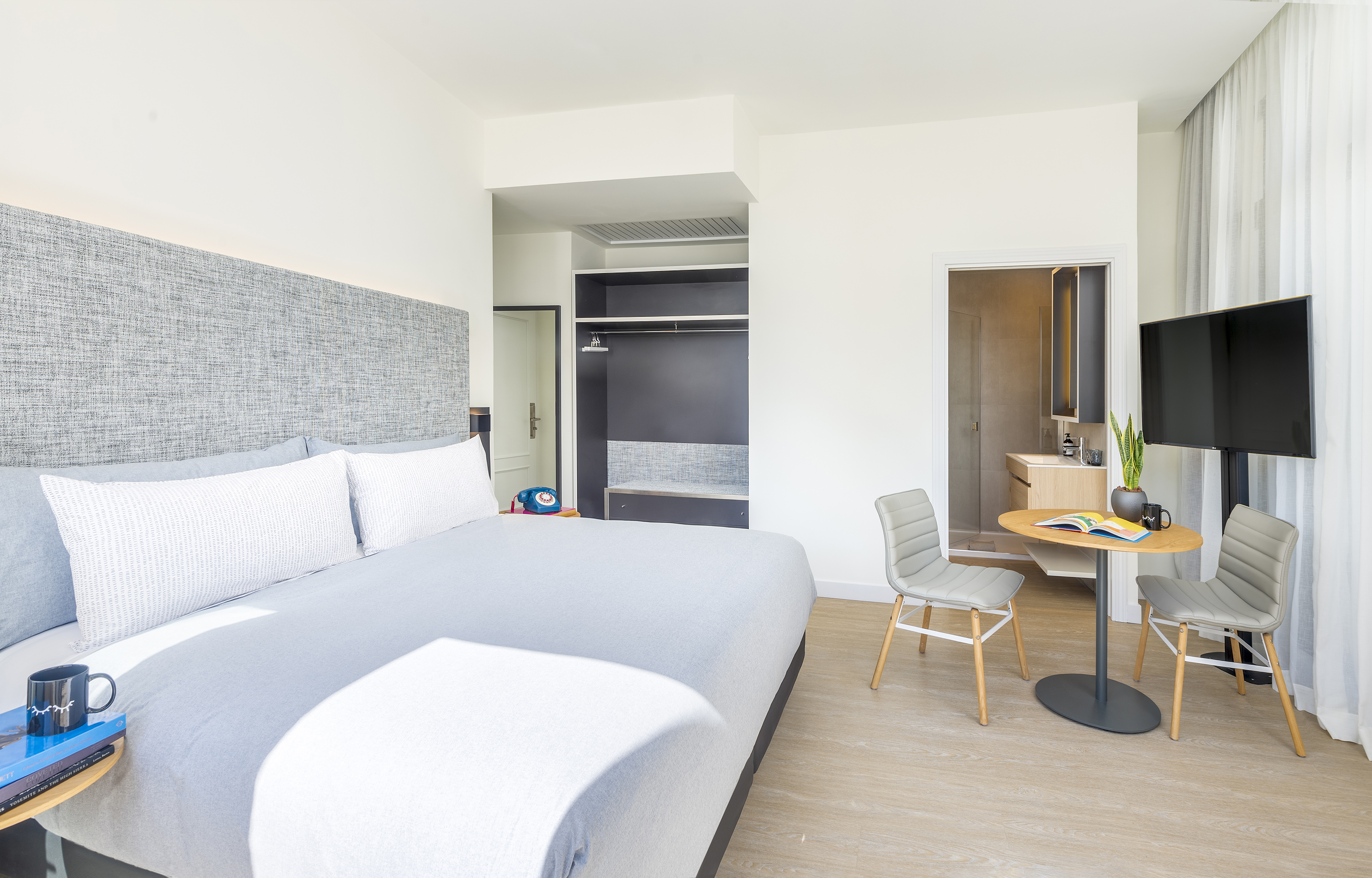 a bedroom with a bed and a desk