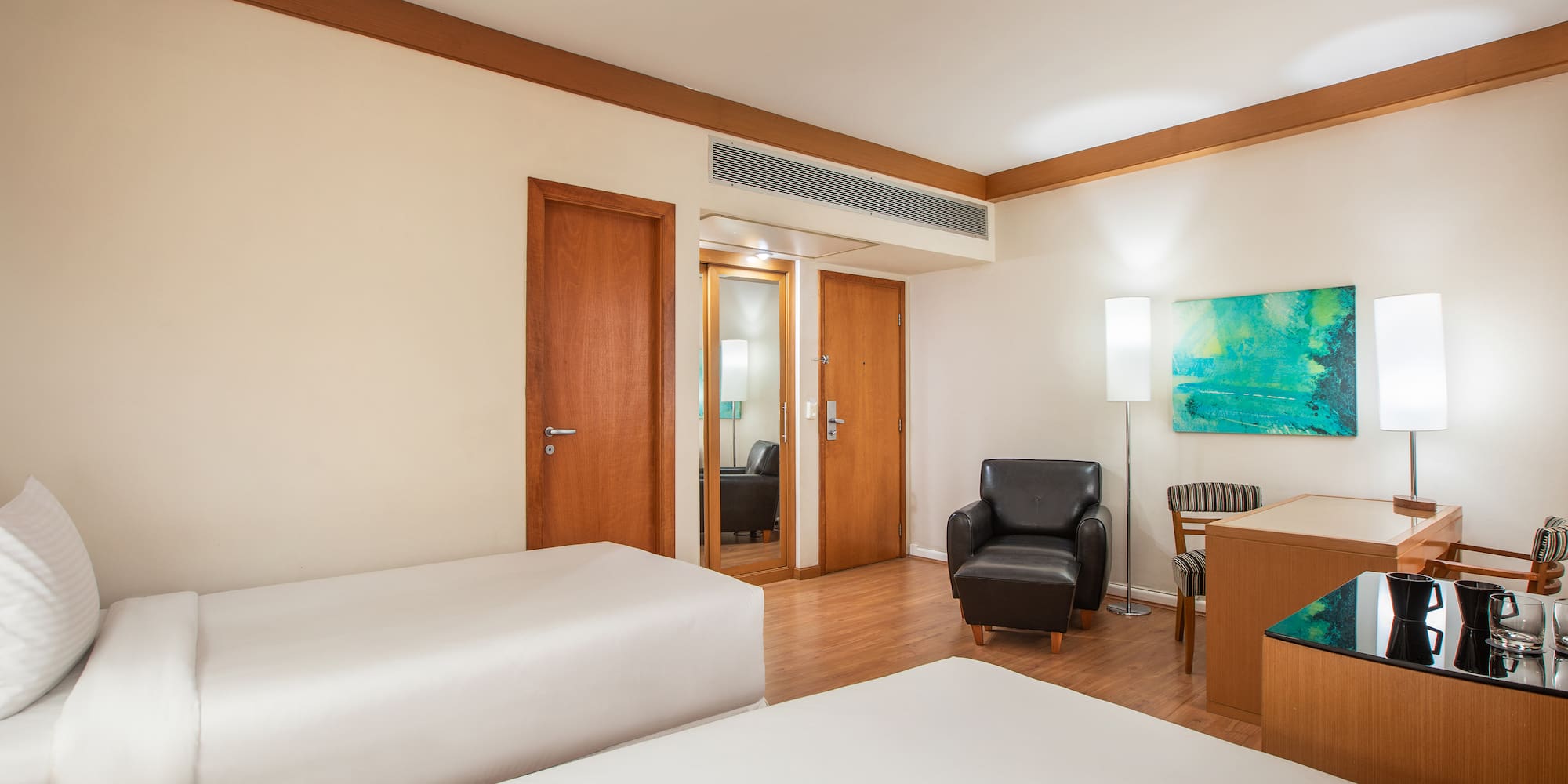 a room with two beds and a chair