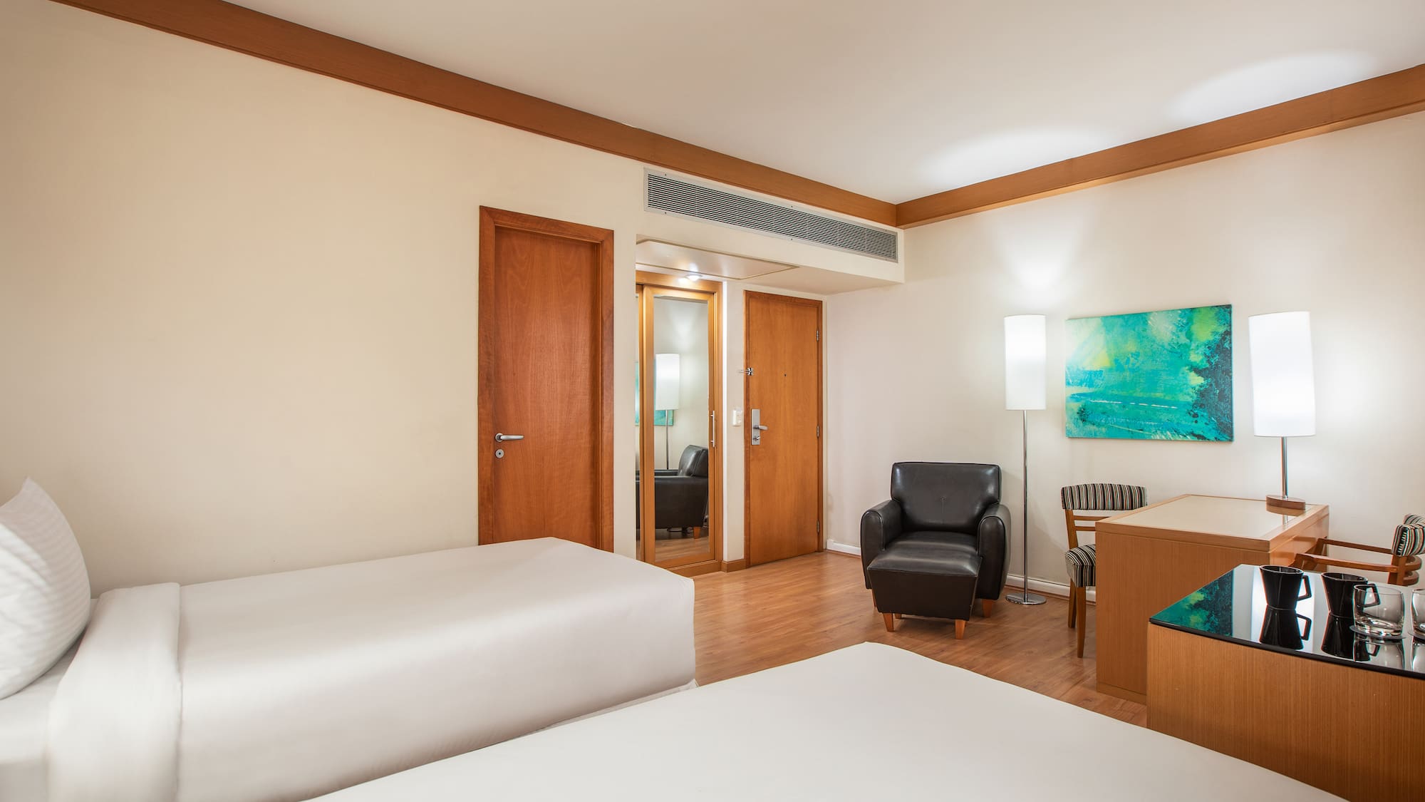 a room with two beds and a chair