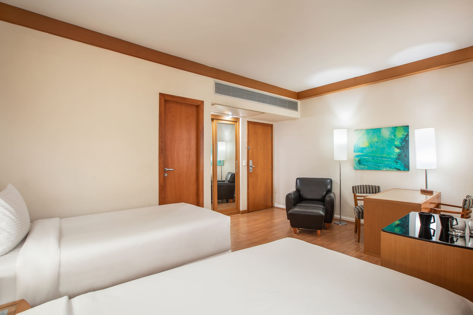 a room with two beds and a chair