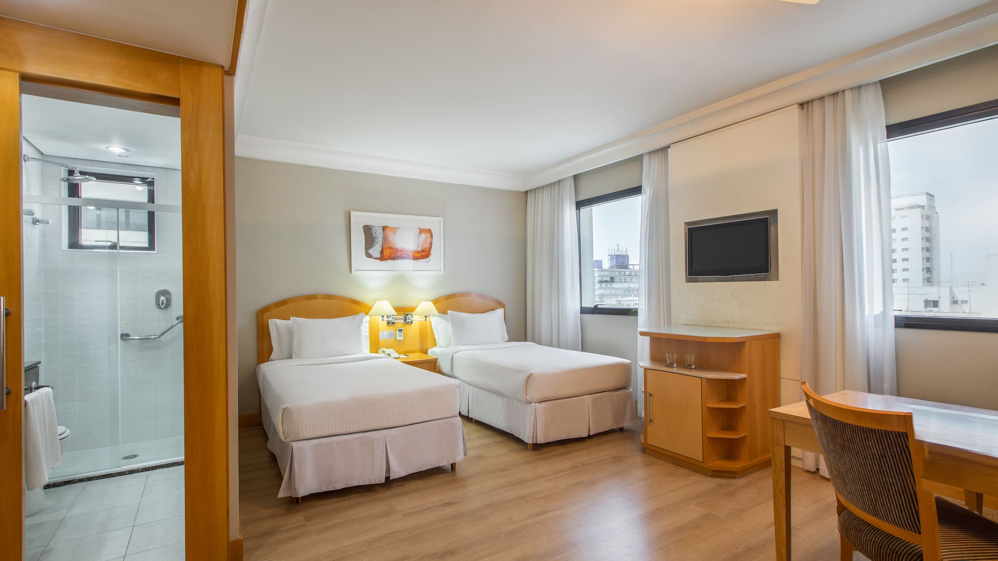 a room with two beds and a tv