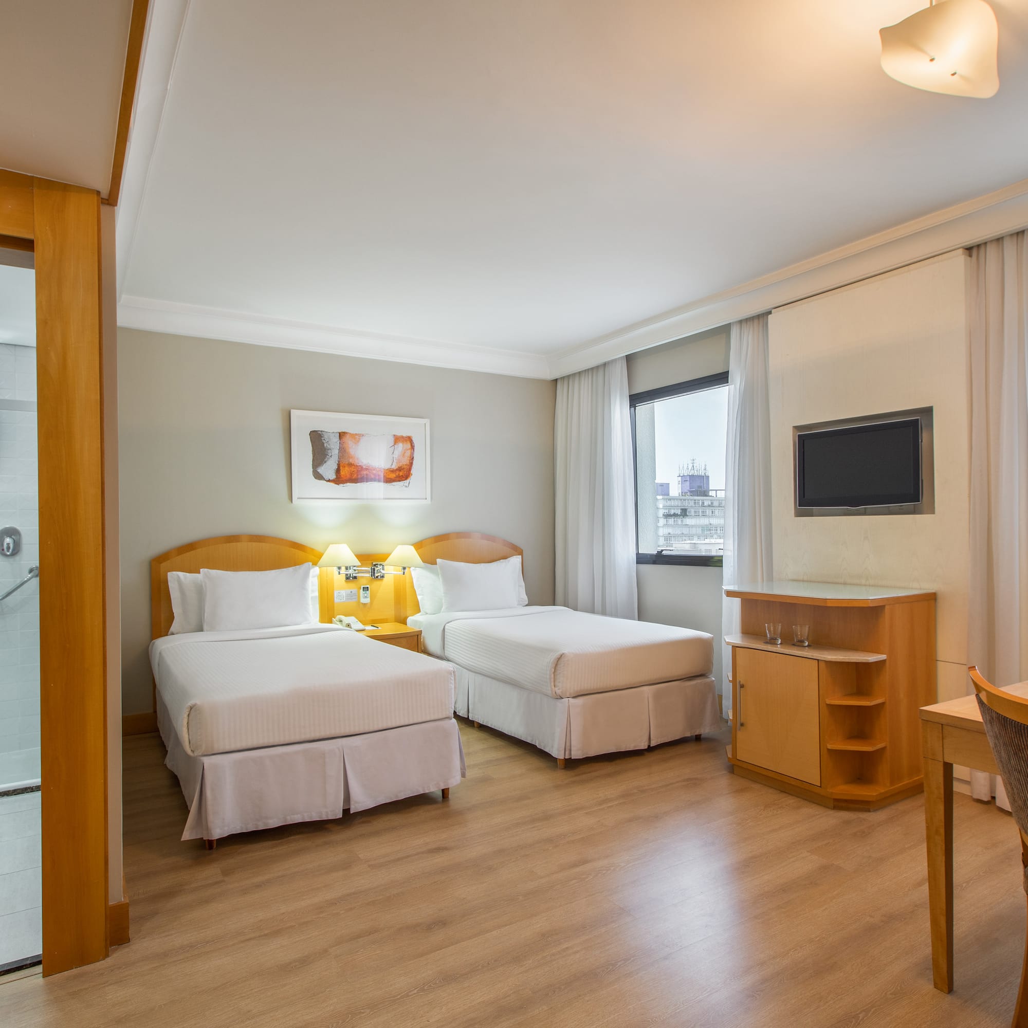 a room with two beds and a tv