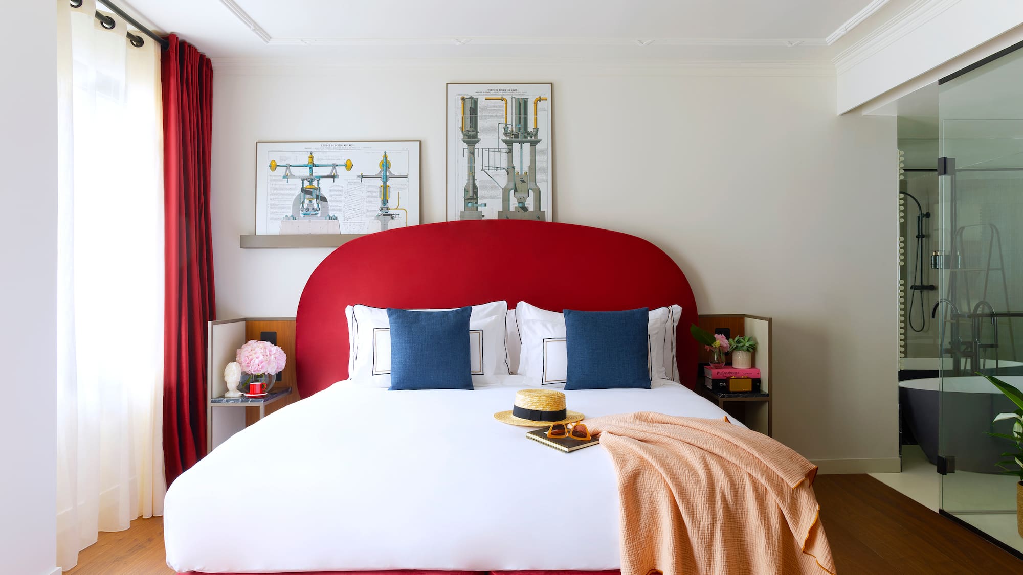 a bed with a red headboard and a blanket