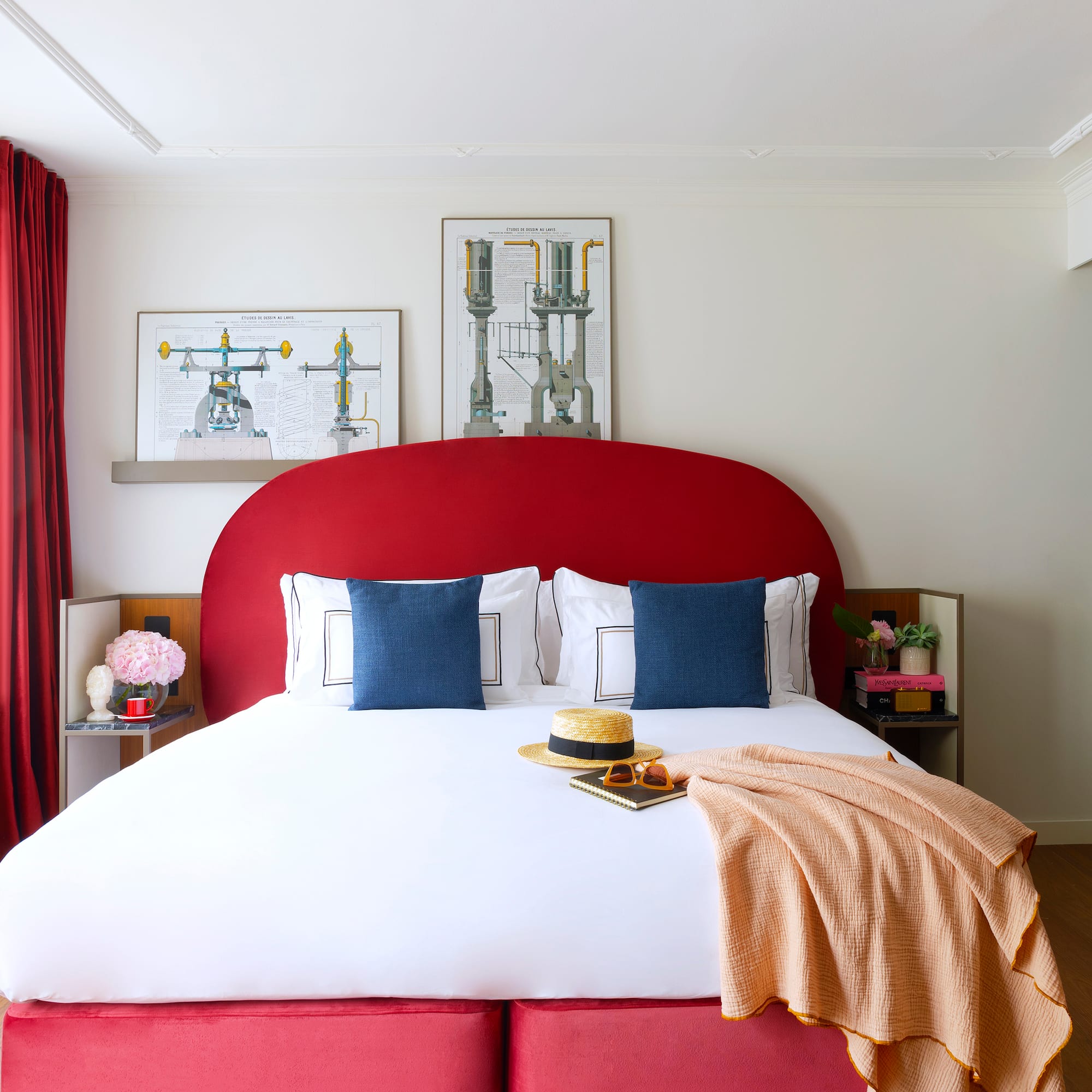 a bed with a red headboard and a blanket