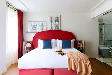 a bed with a red headboard and a blanket
