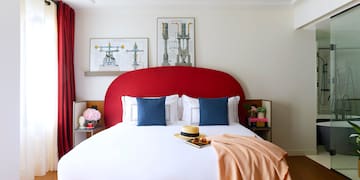 a bed with a red headboard and a blanket