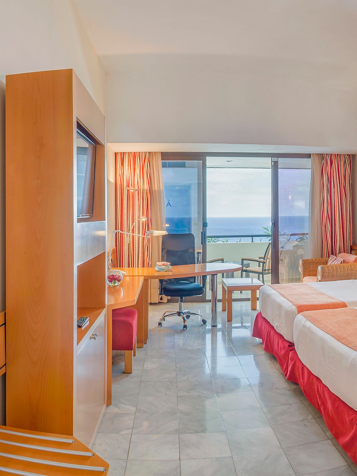 a room with two beds and a television