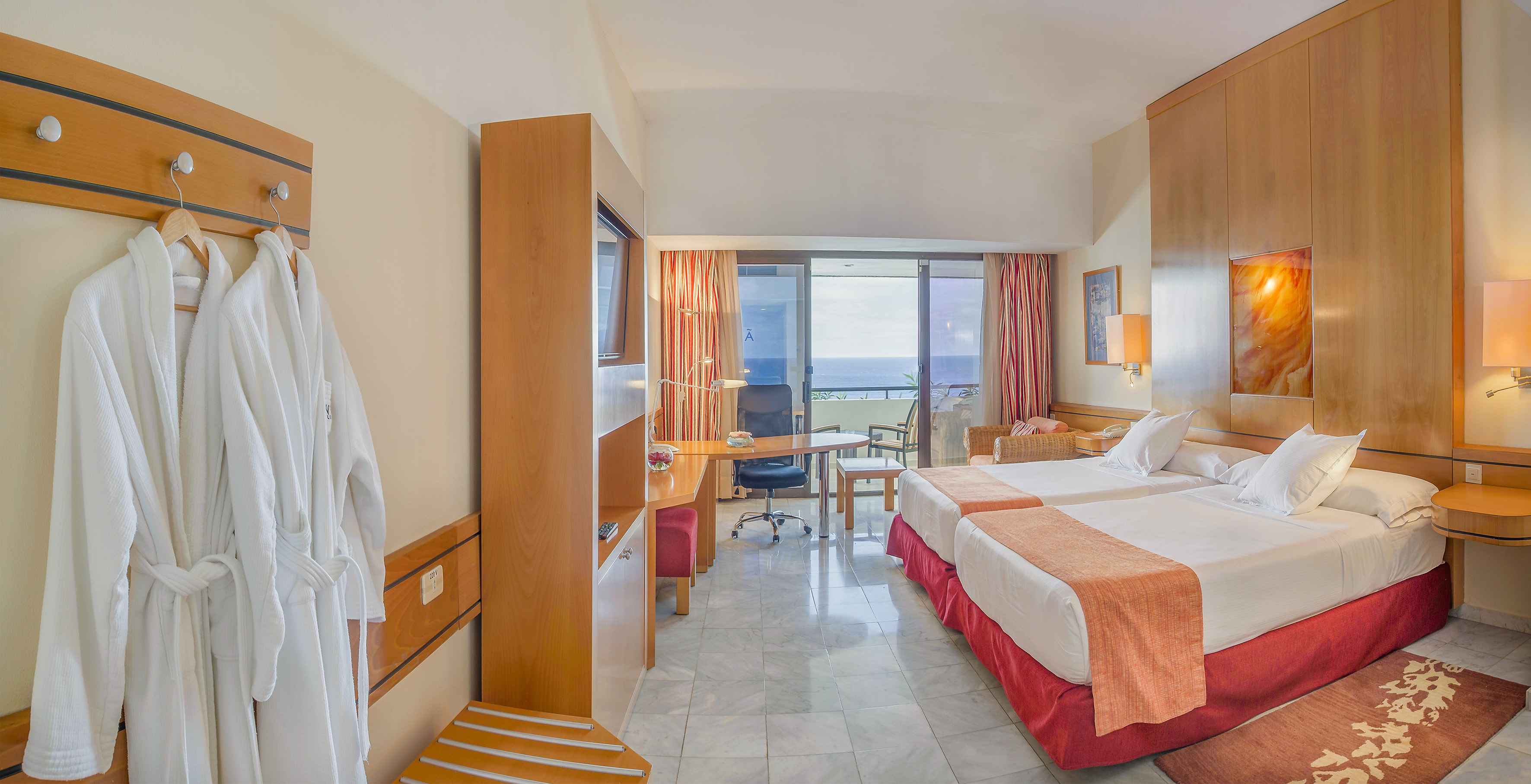 a room with two beds and a television