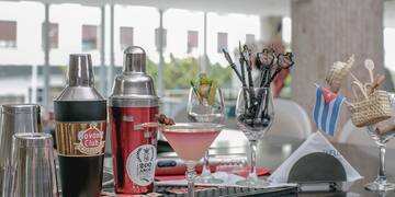 a cocktail shaker and shakers on a table