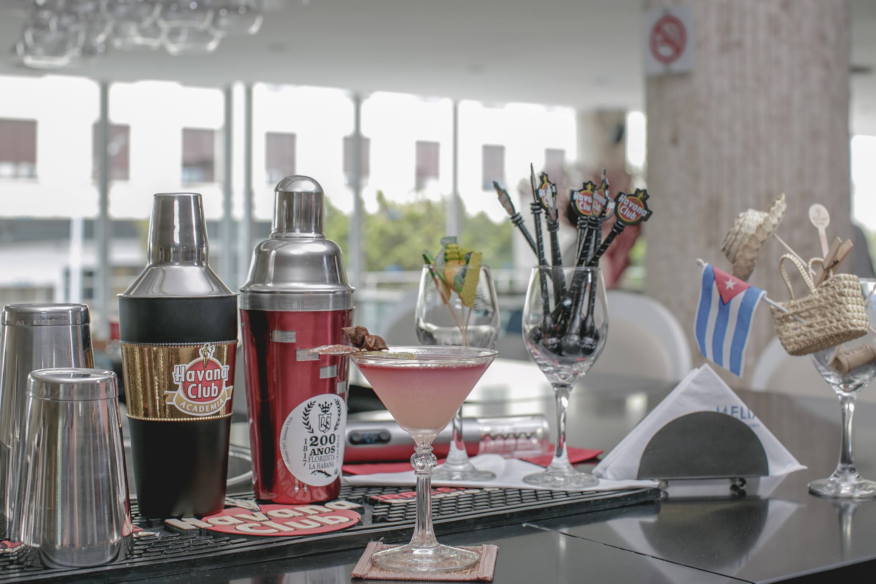a cocktail shaker and shakers on a table