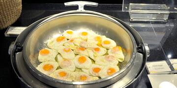 a pan of eggs cooking on a stove